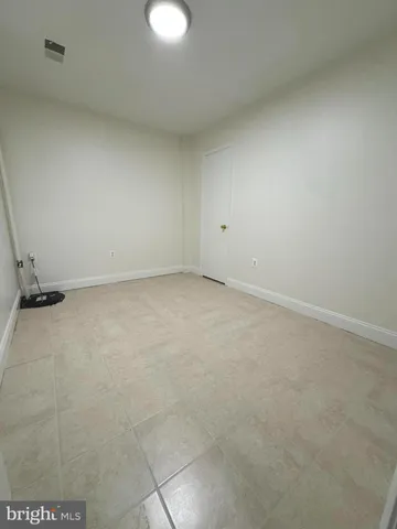 a view of backyard with wooden fence and a large tree