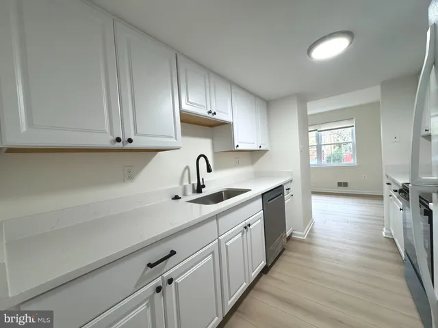 a kitchen with sink cabinets and window