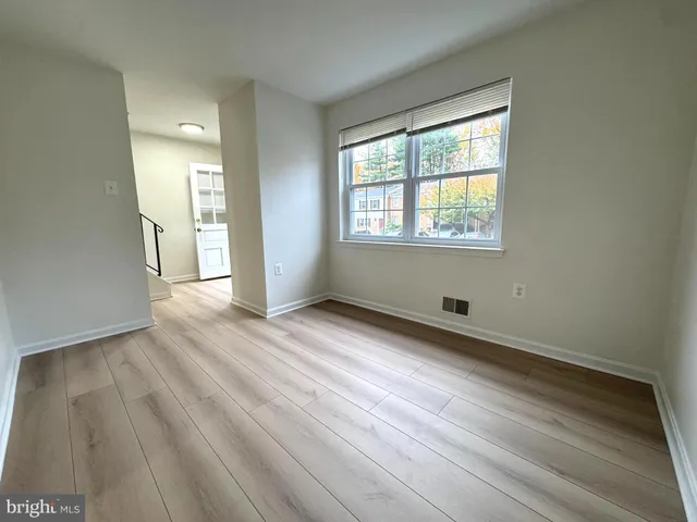 a view of wooden floor and windows in a room