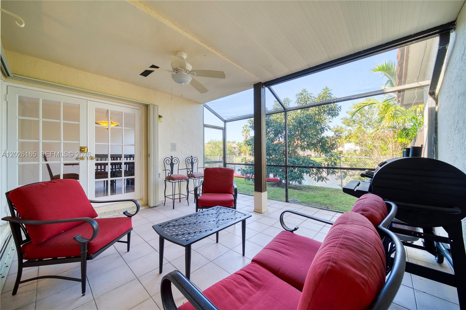 13337 Southwest 64th Lane Miami, FL 33183 - Photo 31 of 36 a living room with furniture and a floor to ceiling window