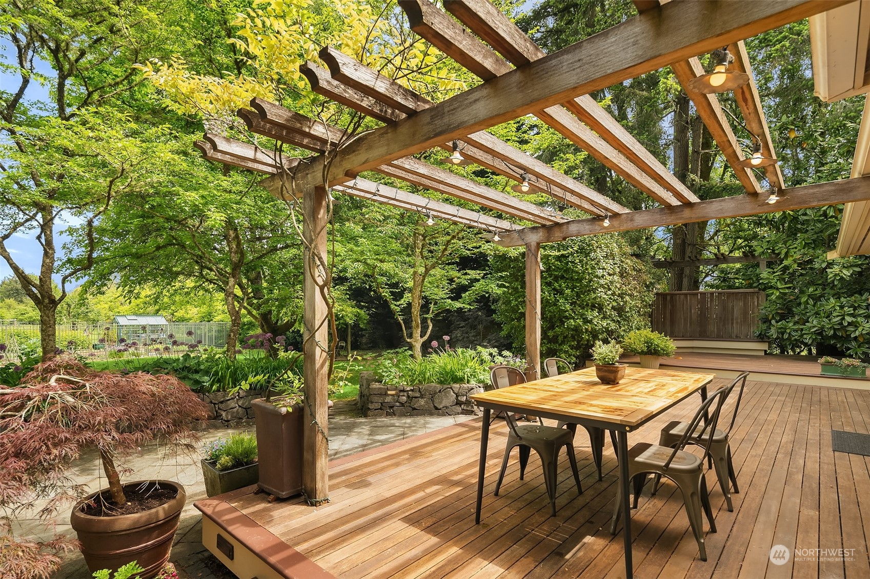 10810 Southwest Bank Road Vashon, WA 98070 - Photo 22 of 34 a view of a patio with table and chairs and potted plants