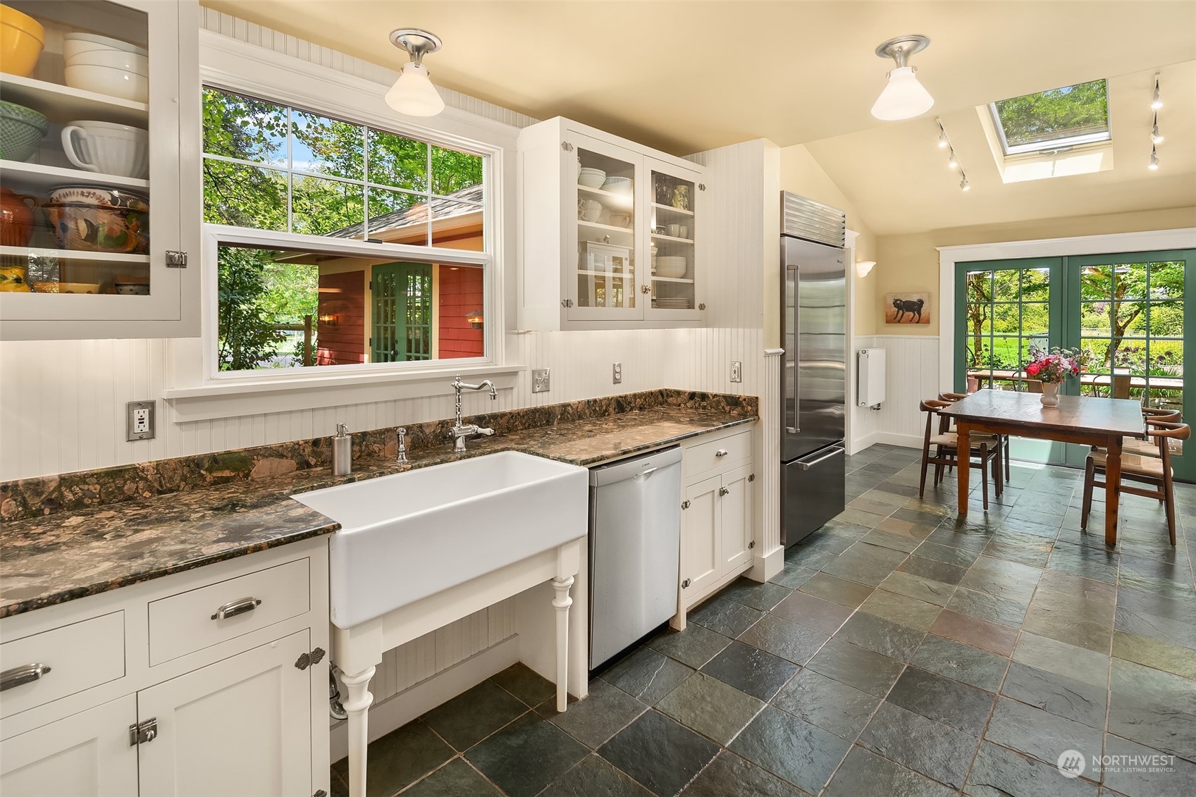 10810 Southwest Bank Road Vashon, WA 98070 - Photo 4 of 34 a kitchen a sink a table and chairs in it