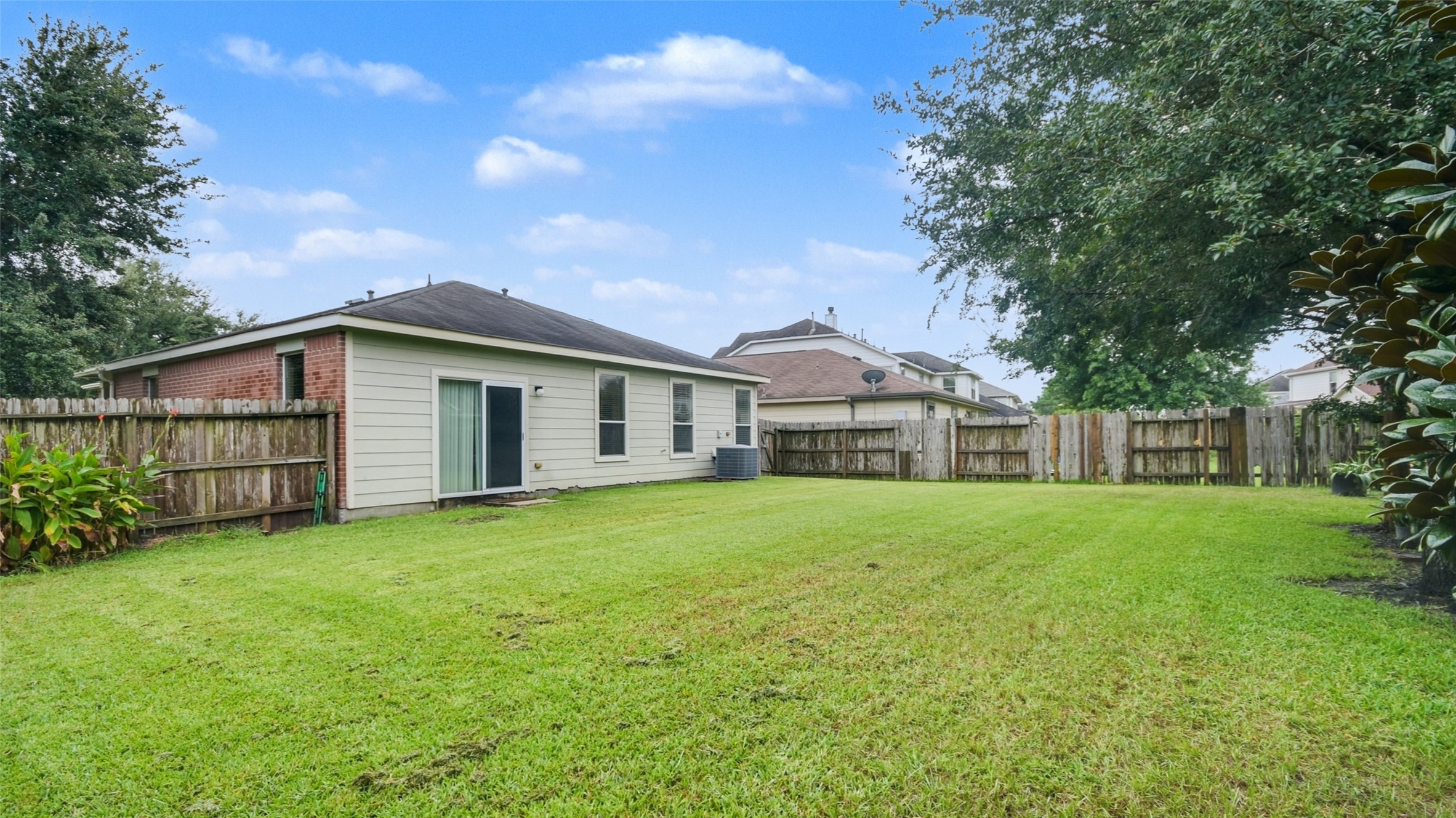 18206 West Ridge Bend Lane Cypress, TX 77433 - Photo 2 of 16 a view of a yard in front of a house with large trees