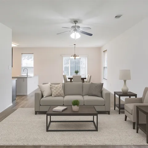 a living room with furniture and a chandelier