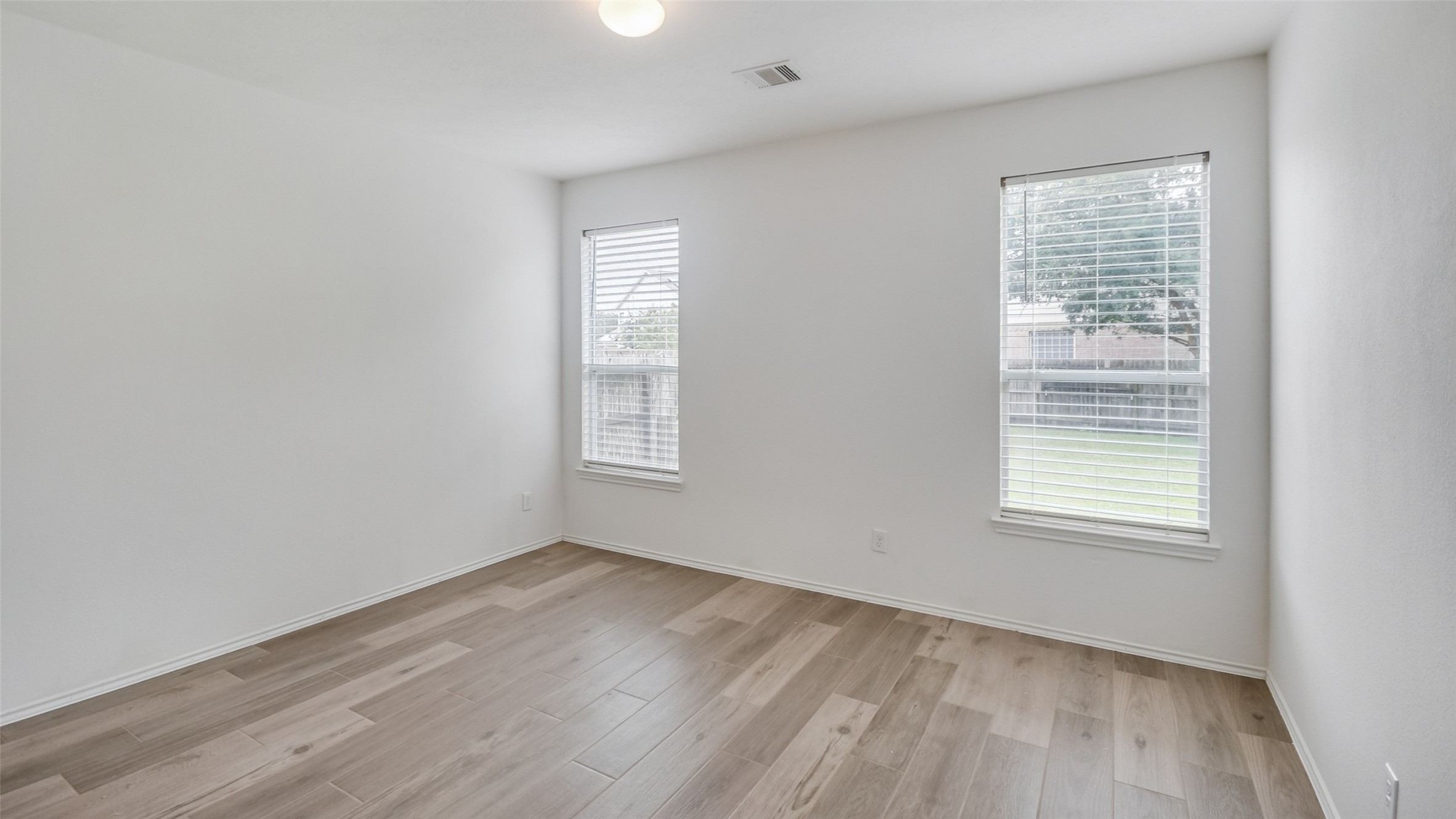 18206 West Ridge Bend Lane Cypress, TX 77433 - Photo 7 of 16 a view of an empty room with wooden floor and a window