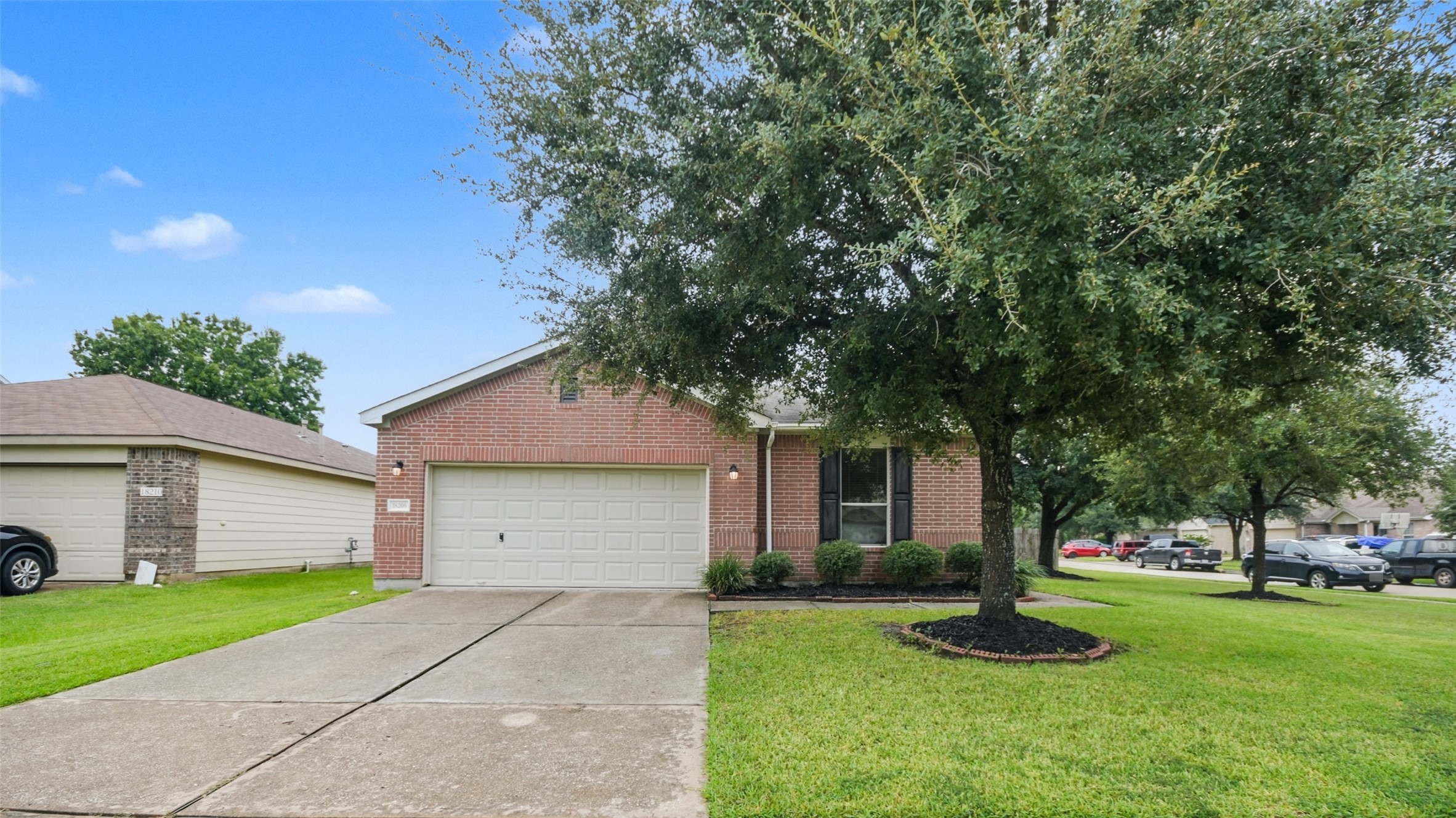18206 West Ridge Bend Lane Cypress, TX 77433 - Photo 10 of 16 a front view of a house with a yard and garage