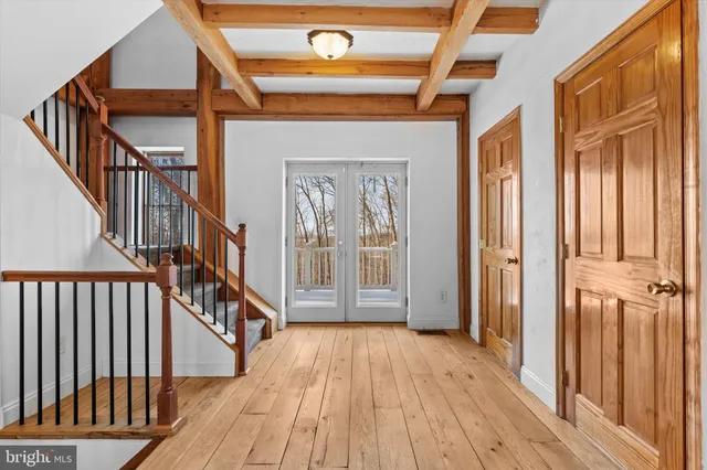 a view of an entryway with wooden floor and door