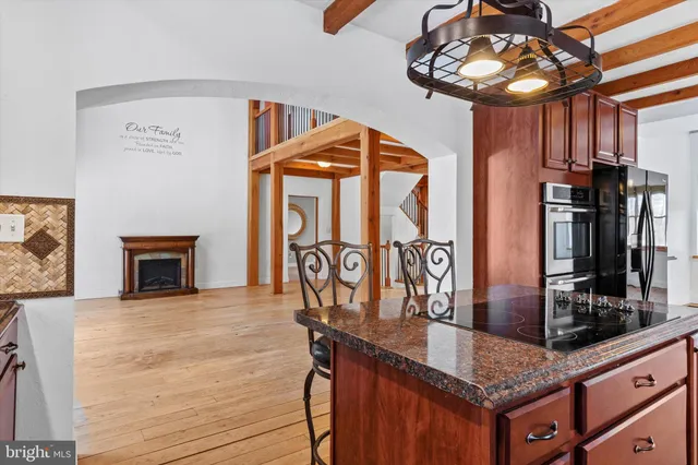a view of a kitchen with granite countertop a stove and a sink
