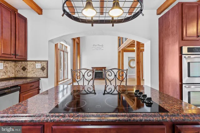 a kitchen with stainless steel appliances a stove and a microwave