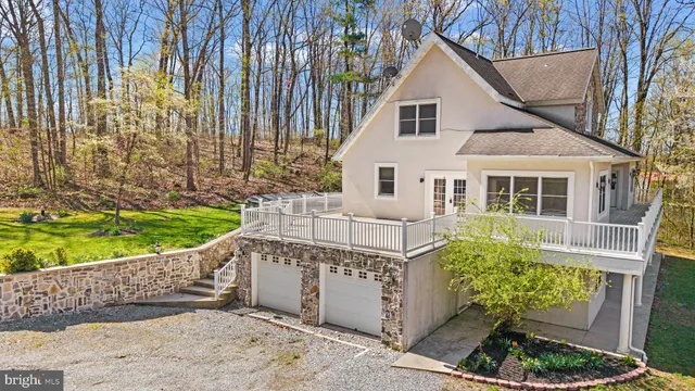 a view of a house with a small yard and potted plants