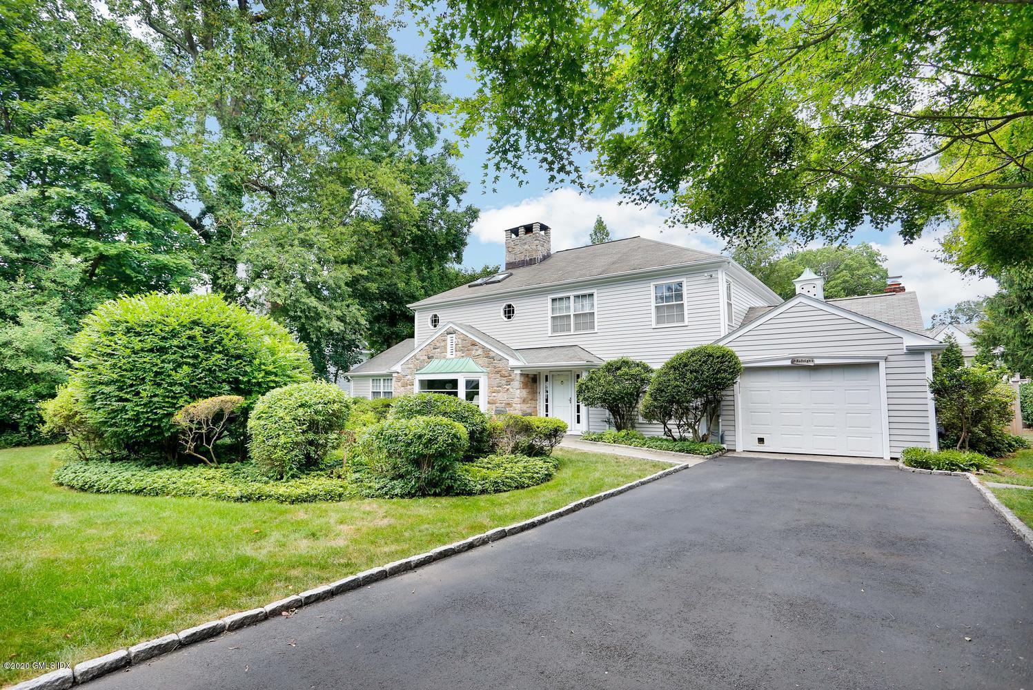 91 Winthrop Drive Riverside, CT 06878 - Photo 1 of 30 a front view of a house with a yard and garage