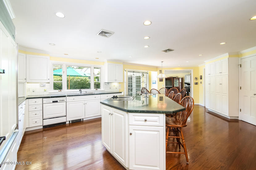 91 Winthrop Drive Riverside, CT 06878 - Photo 11 of 30 a kitchen with stainless steel appliances granite countertop a sink a stove a dining table and chairs