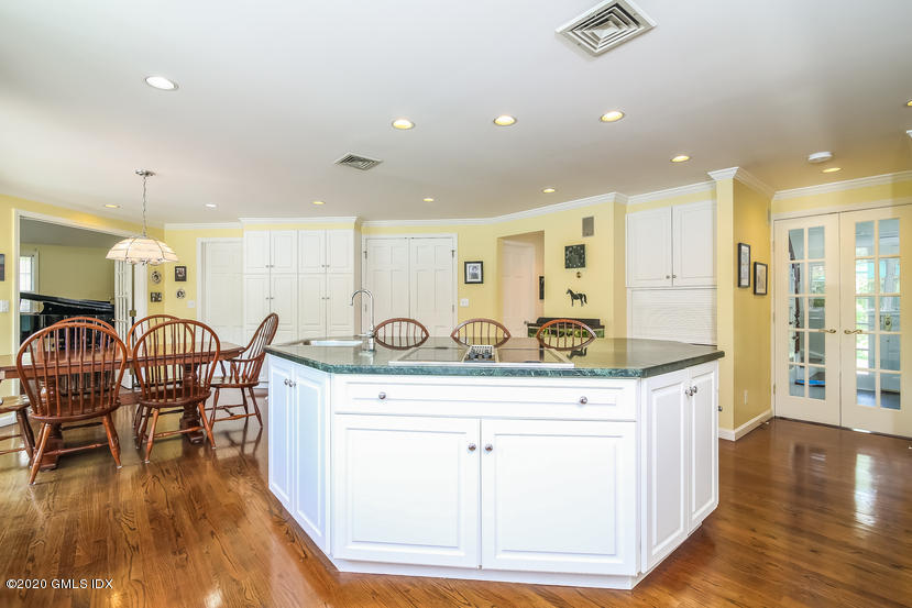 91 Winthrop Drive Riverside, CT 06878 - Photo 12 of 30 a view of a kitchen with kitchen island granite countertop wooden floors and white cabinets