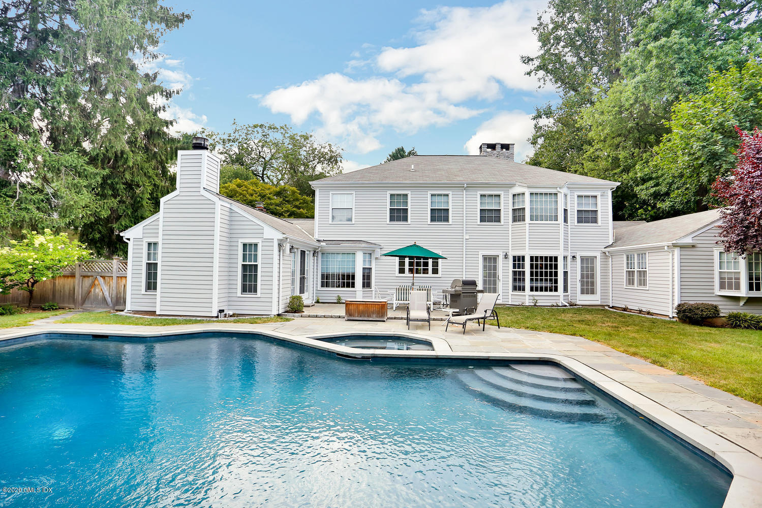 91 Winthrop Drive Riverside, CT 06878 - Photo 2 of 30 a view of a house with pool and chairs