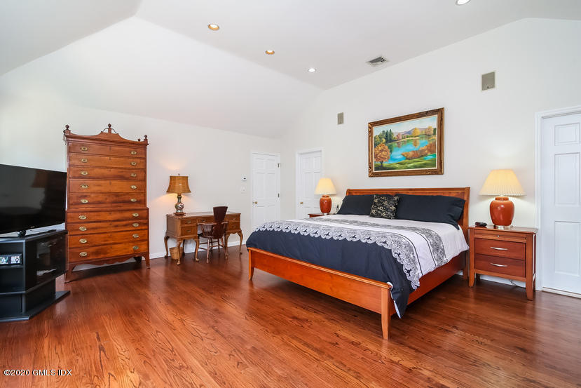 91 Winthrop Drive Riverside, CT 06878 - Photo 22 of 30 a bedroom with a bed and wooden floor