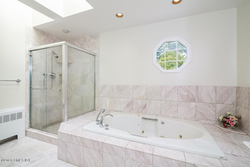 91 Winthrop Drive Riverside, CT 06878 - Photo 23 of 30 a bathroom with a sink a bathtub and a shower