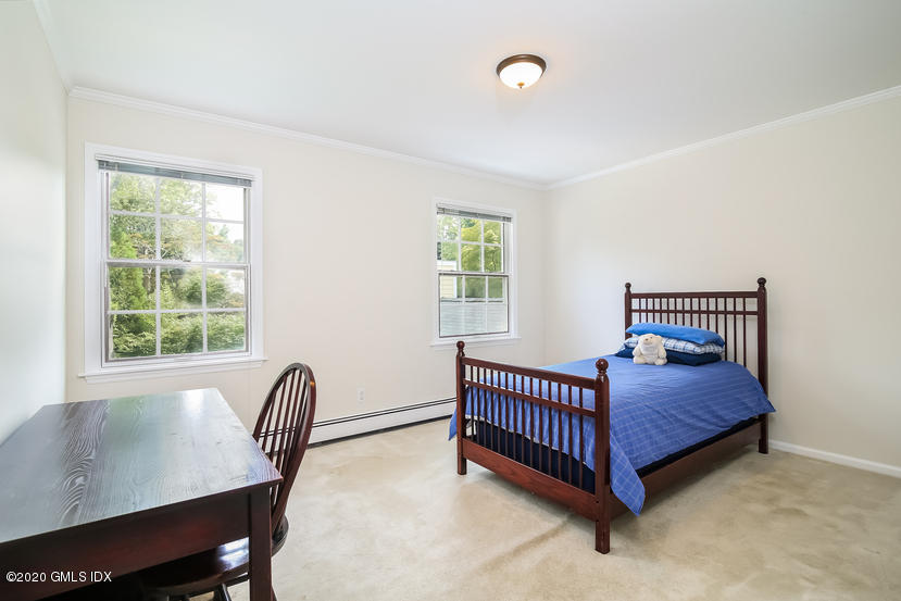 91 Winthrop Drive Riverside, CT 06878 - Photo 26 of 30 a bed sitting in a bedroom next to a window