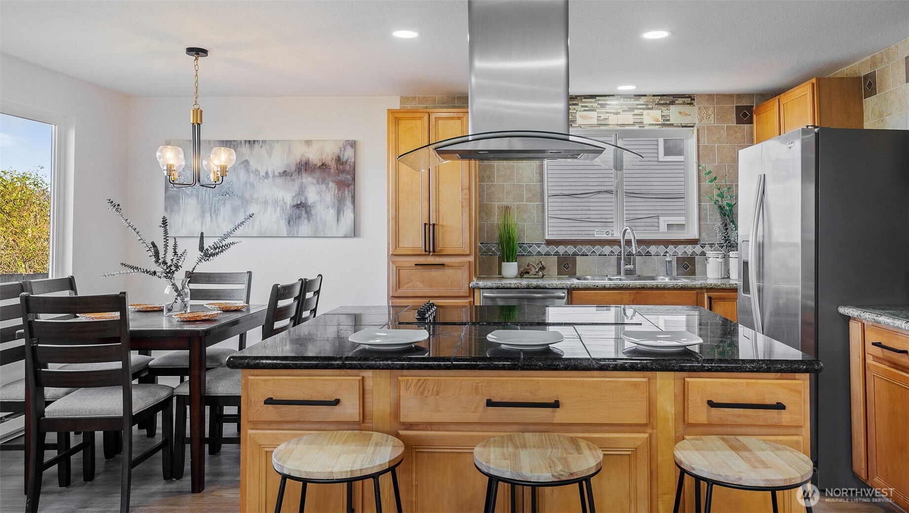 2520 Chestnut Street Everett, WA 98201 - Photo 7 of 29 a kitchen with granite countertop a table chairs stove a refrigerator and cabinets