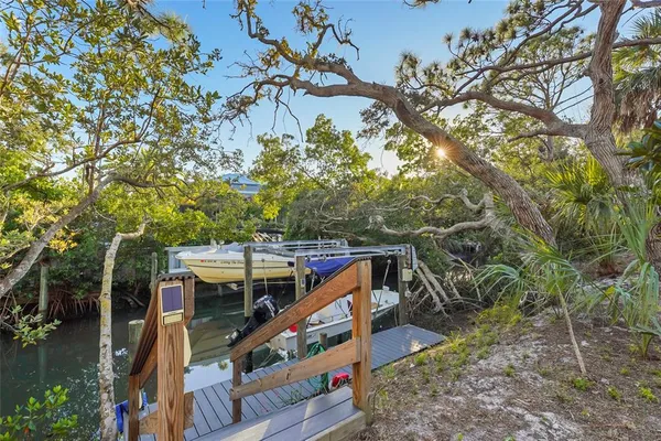 a view of a wooden deck and a backyard
