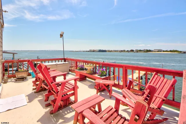 a view of swimming pool with outdoor seating and city view