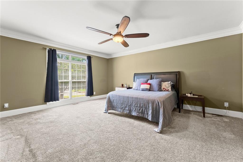 6643 Windvane Point Clermont, GA 30527 - Photo 24 of 88 a bedroom with a bed and window