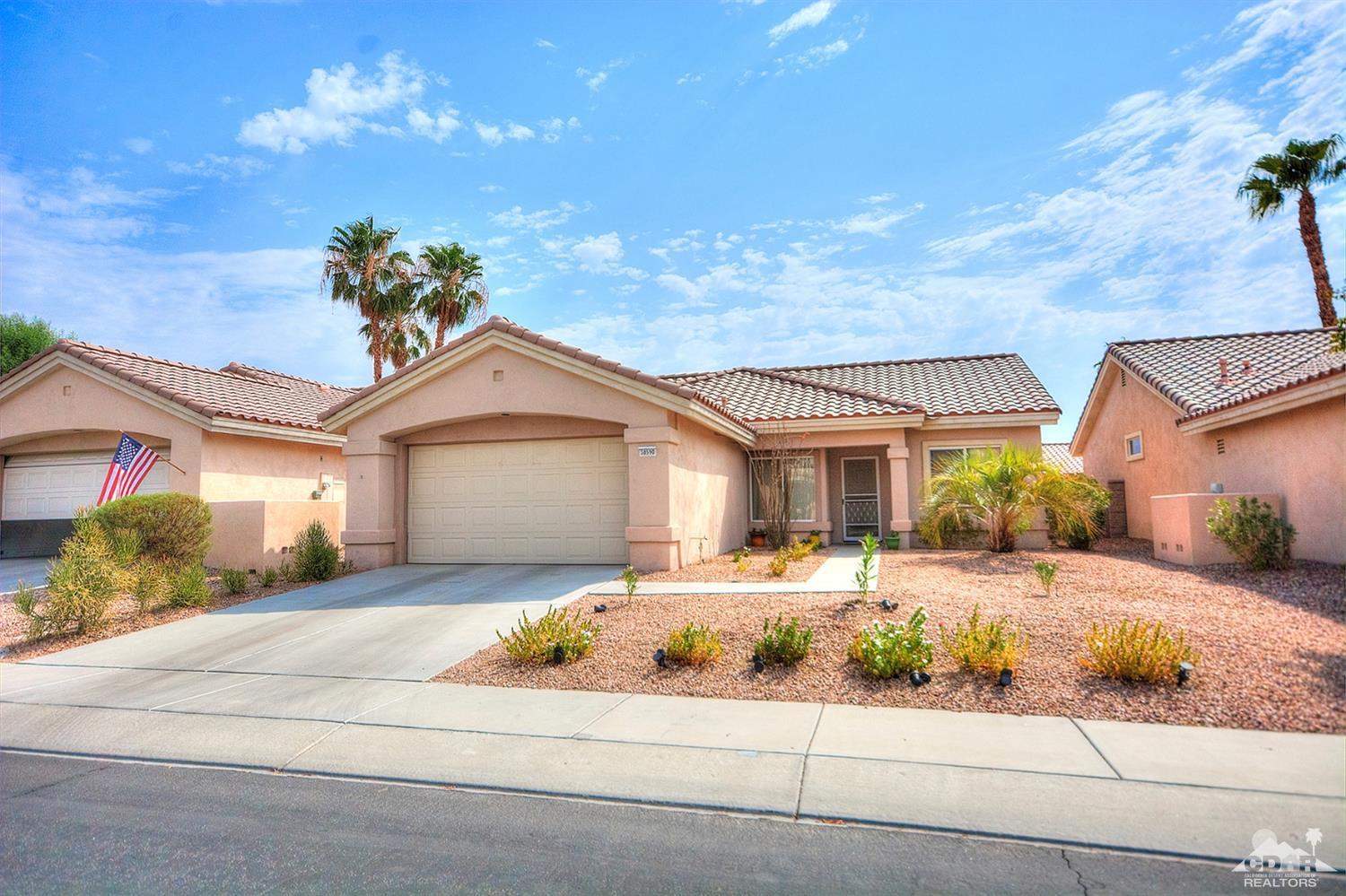 38590 Orangecrest Road Palm Desert, CA 92211 - Photo 2 of 23 a front view of a house with a yard and garage