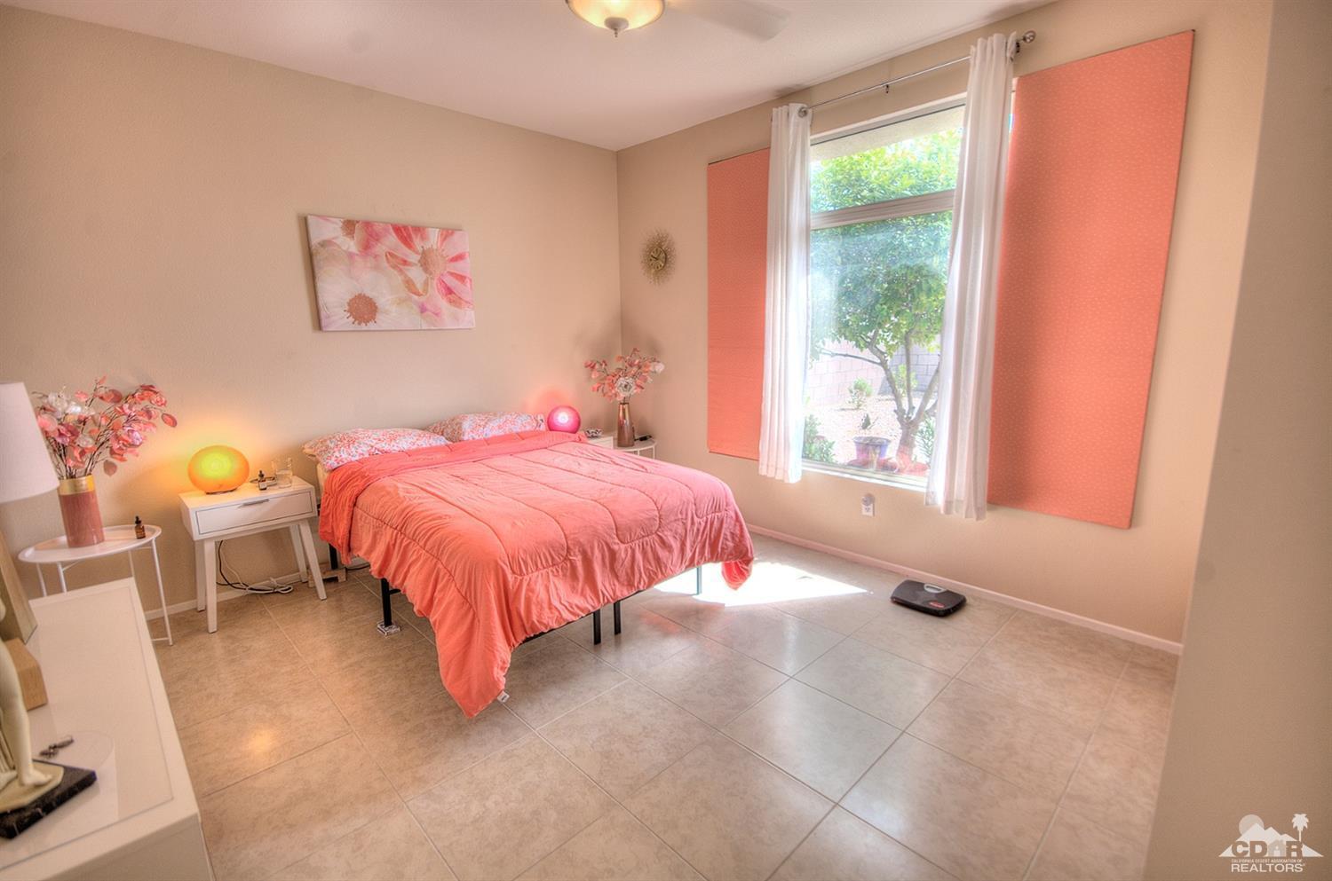 38590 Orangecrest Road Palm Desert, CA 92211 - Photo 11 of 23 a bed sitting in a bedroom next to a window