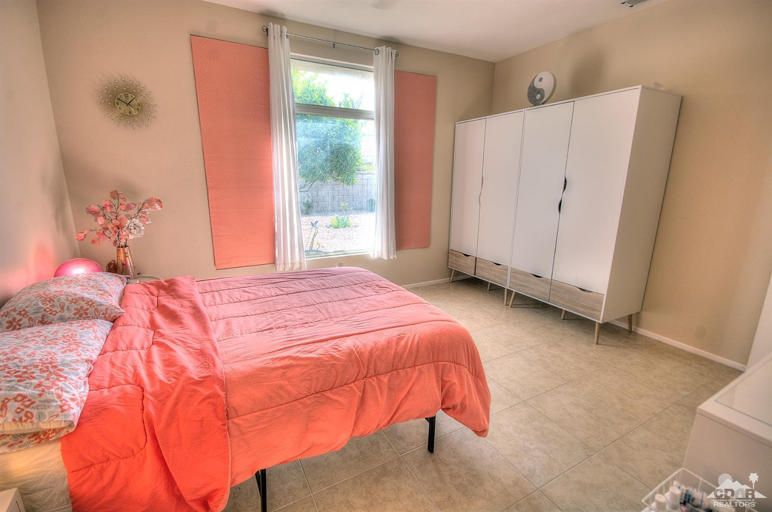 38590 Orangecrest Road Palm Desert, CA 92211 - Photo 12 of 23 a bedroom with a bed and a window