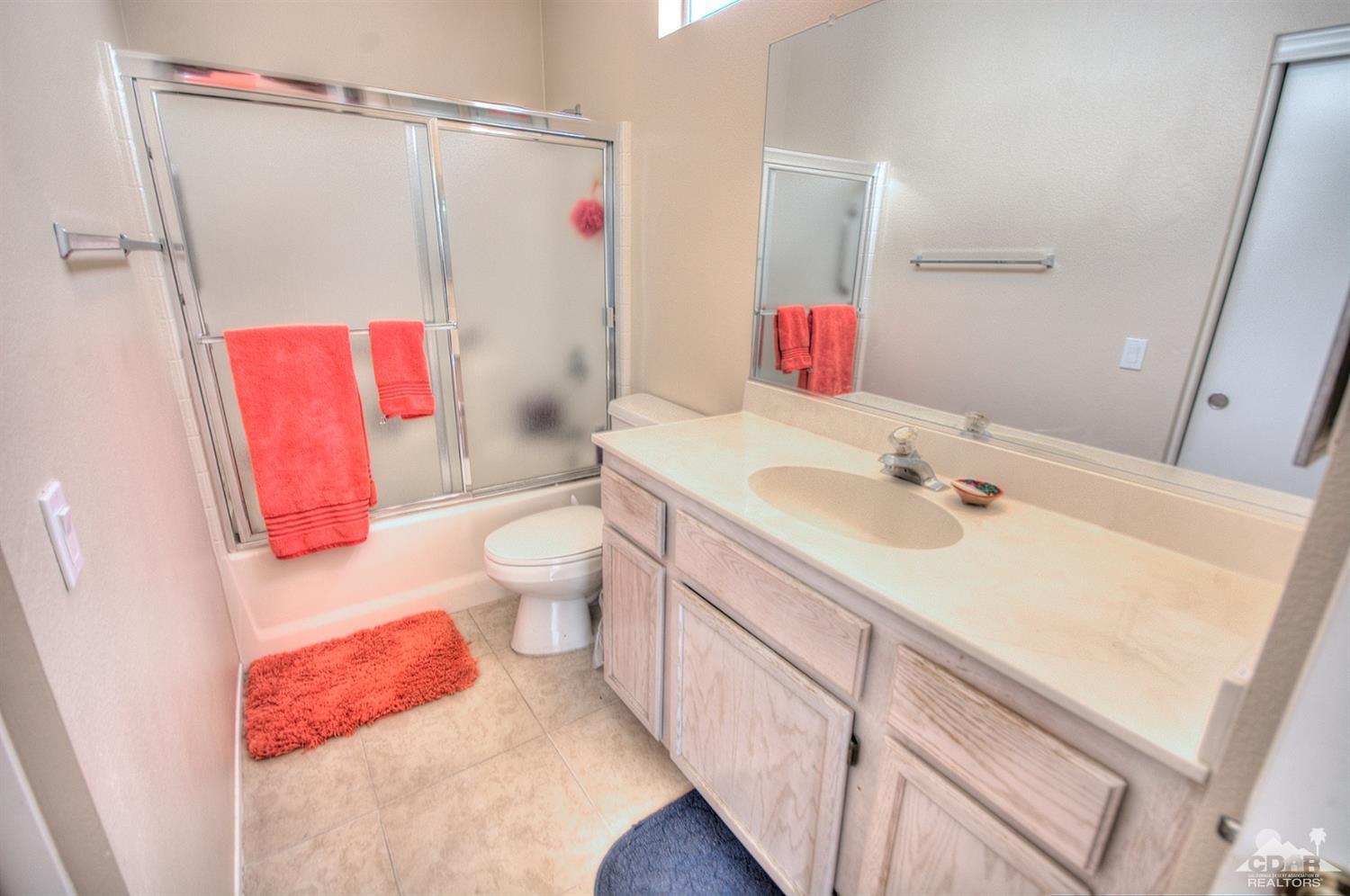 38590 Orangecrest Road Palm Desert, CA 92211 - Photo 13 of 23 a bathroom with a sink vanity mirror and toilet