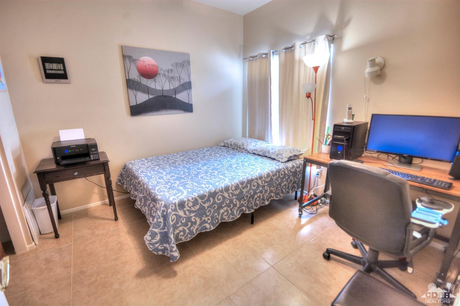 38590 Orangecrest Road Palm Desert, CA 92211 - Photo 14 of 23 a bedroom with a bed a desk and chair