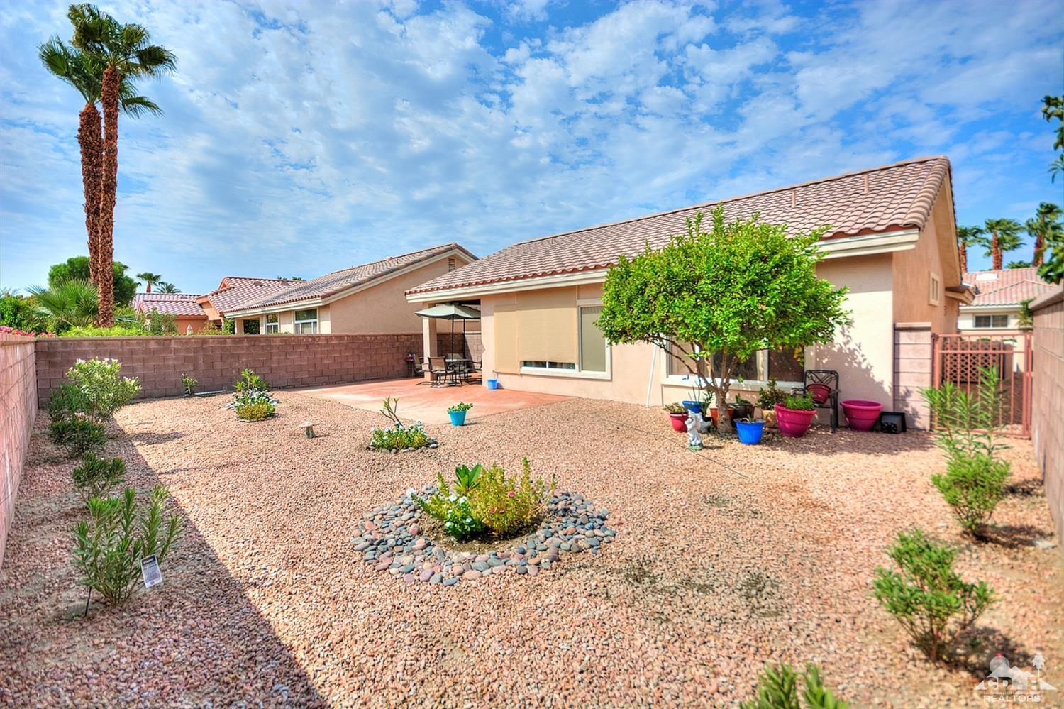 38590 Orangecrest Road Palm Desert, CA 92211 - Photo 19 of 23 a front view of a house with yard and garage