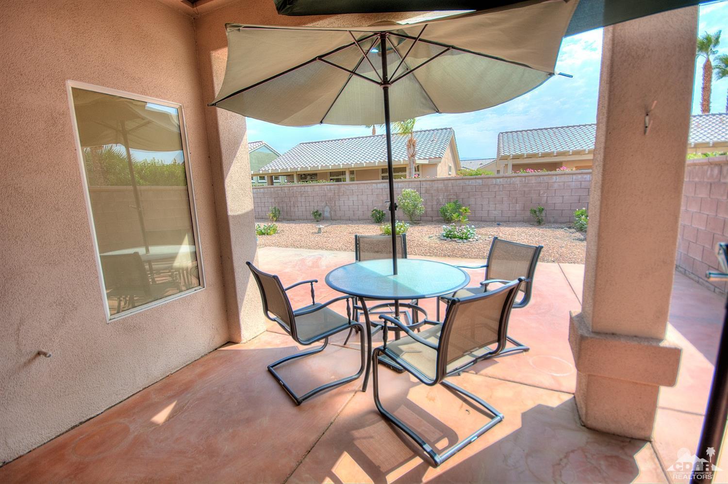 38590 Orangecrest Road Palm Desert, CA 92211 - Photo 20 of 23 a view of a dining room with furniture and a window