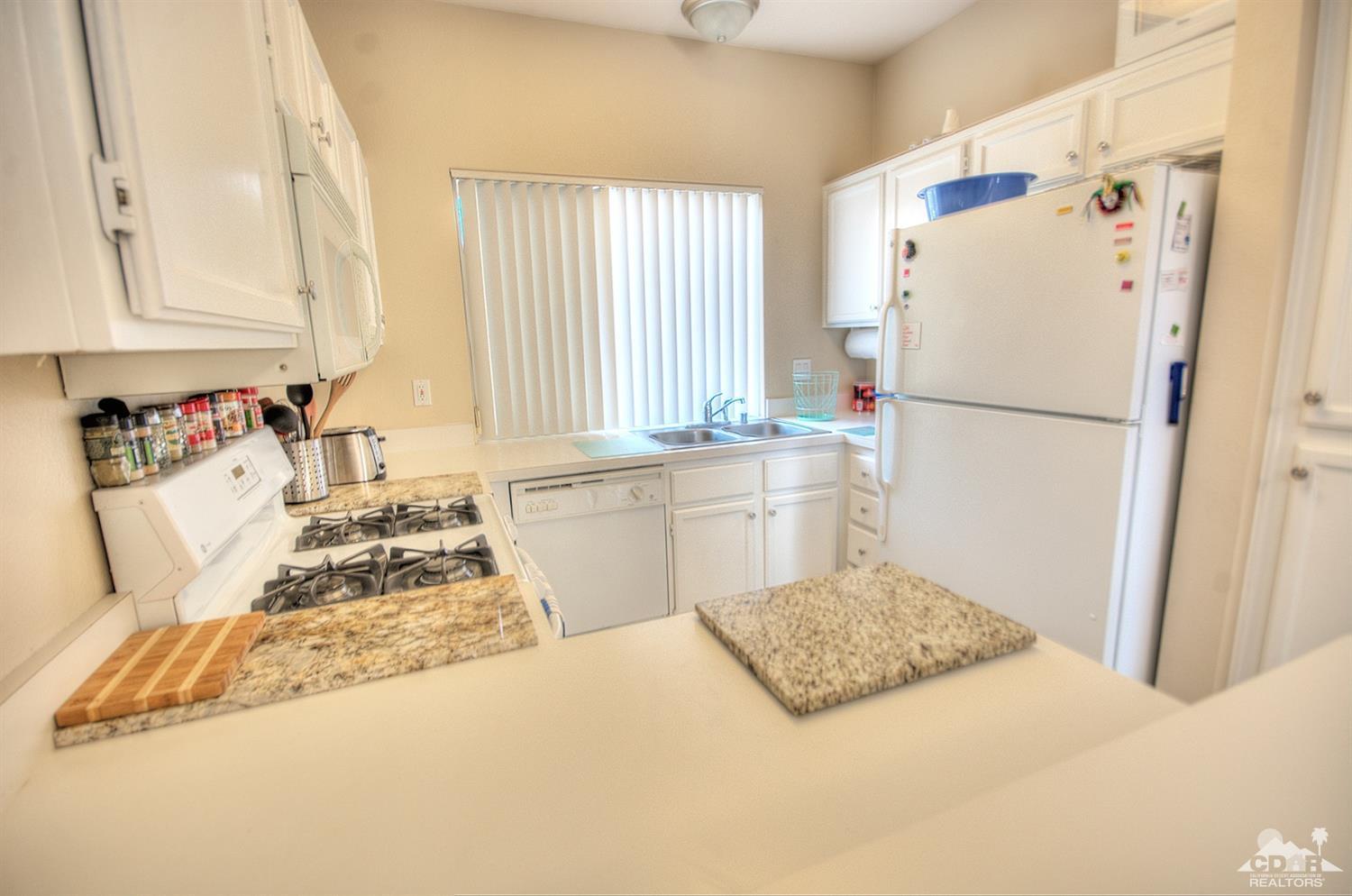 38590 Orangecrest Road Palm Desert, CA 92211 - Photo 8 of 23 a bedroom with a bed and a window
