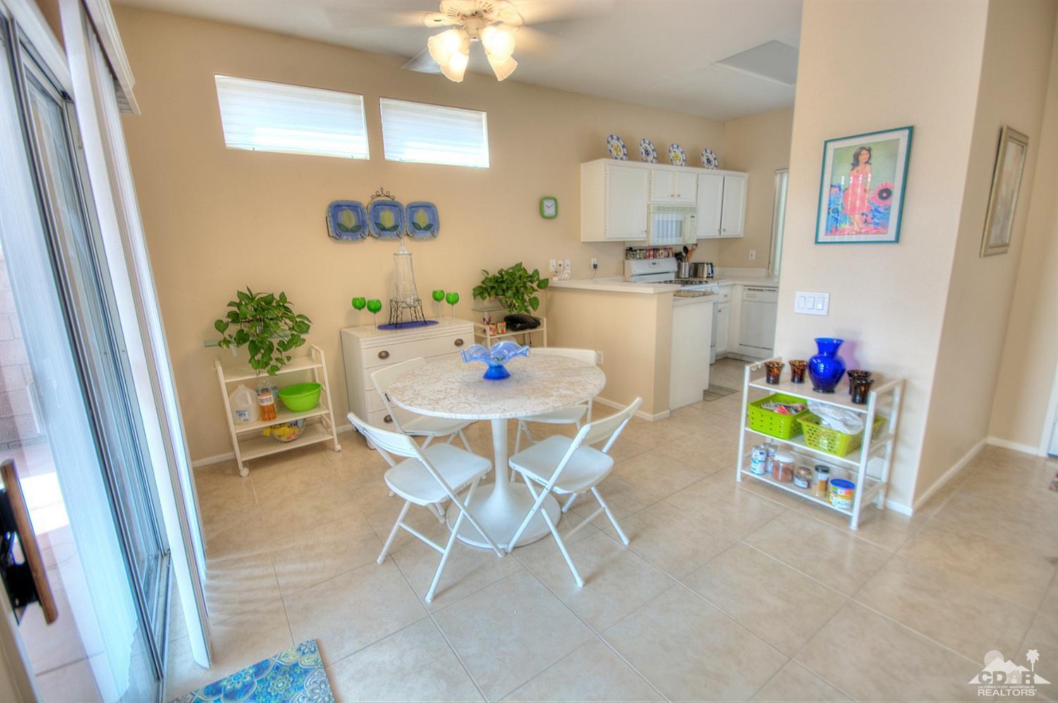 38590 Orangecrest Road Palm Desert, CA 92211 - Photo 9 of 23 a view of a dining room with furniture window and wooden floor