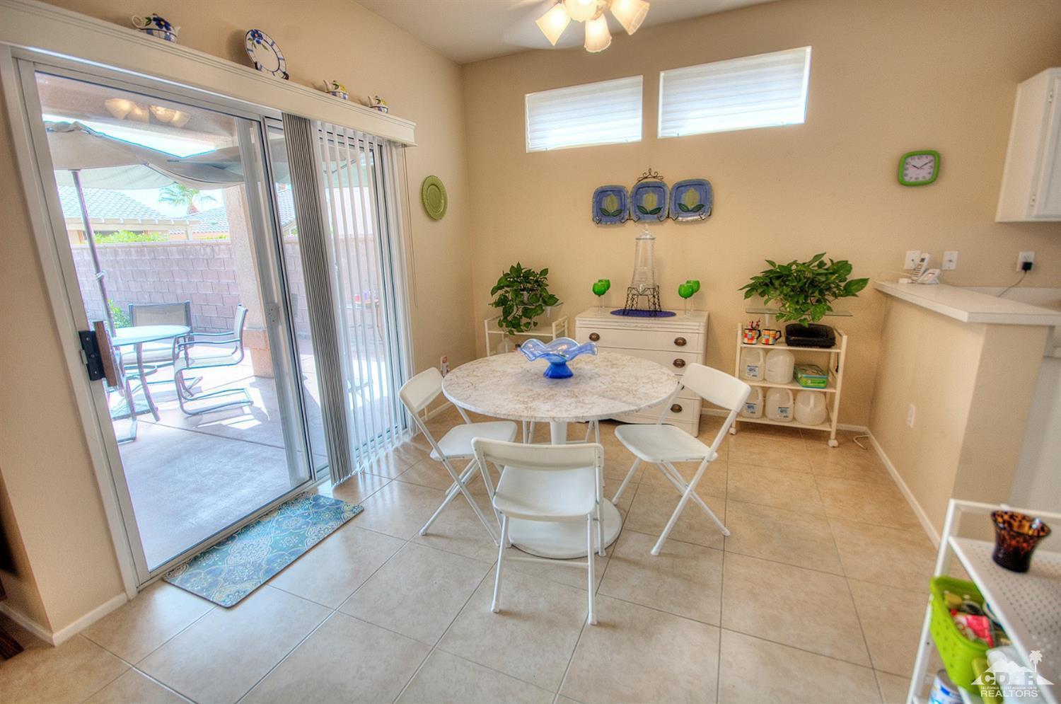 38590 Orangecrest Road Palm Desert, CA 92211 - Photo 10 of 23 a dining room with furniture and a floor to ceiling window