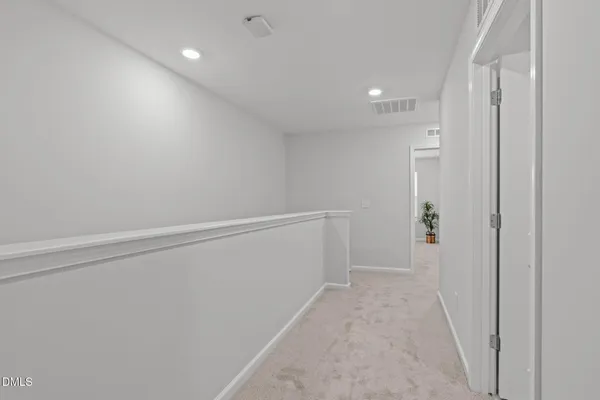 a living room with a bed furniture and a chandelier