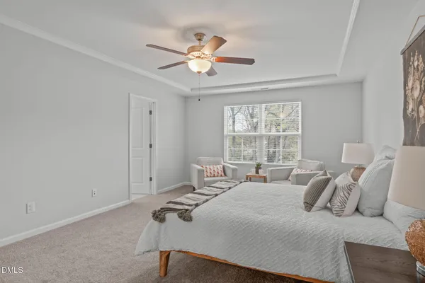 a bedroom with a bed and a ceiling fan
