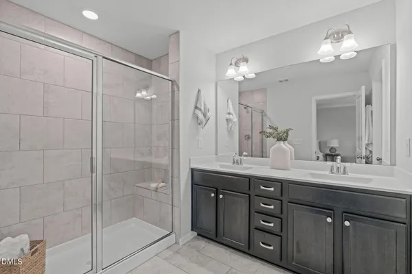 a bathroom with a shower sink and mirror
