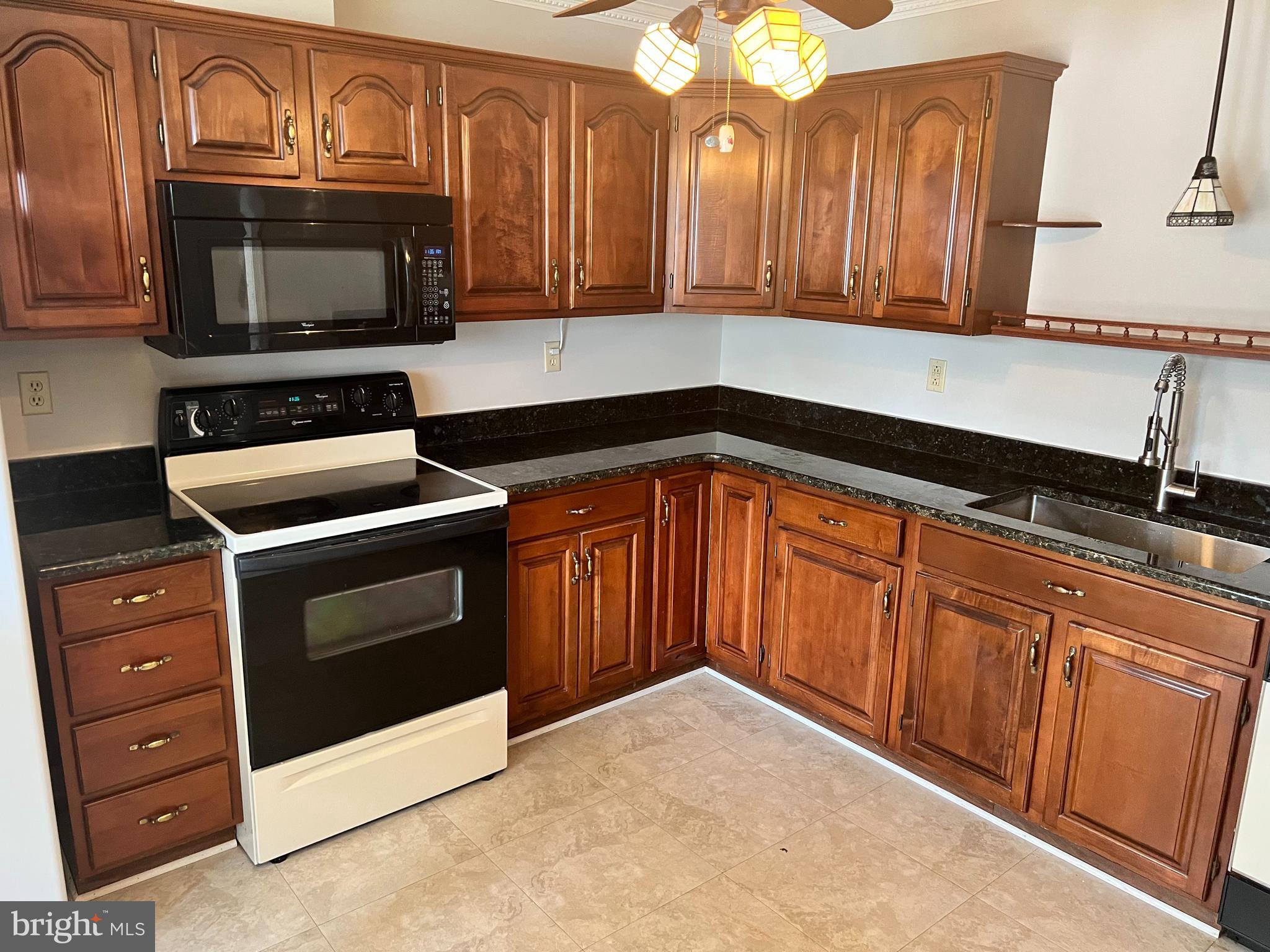 2053 Raleigh Road Hummelstown, PA 17036 - Photo 3 of 22 a kitchen with granite countertop a stove microwave and oven