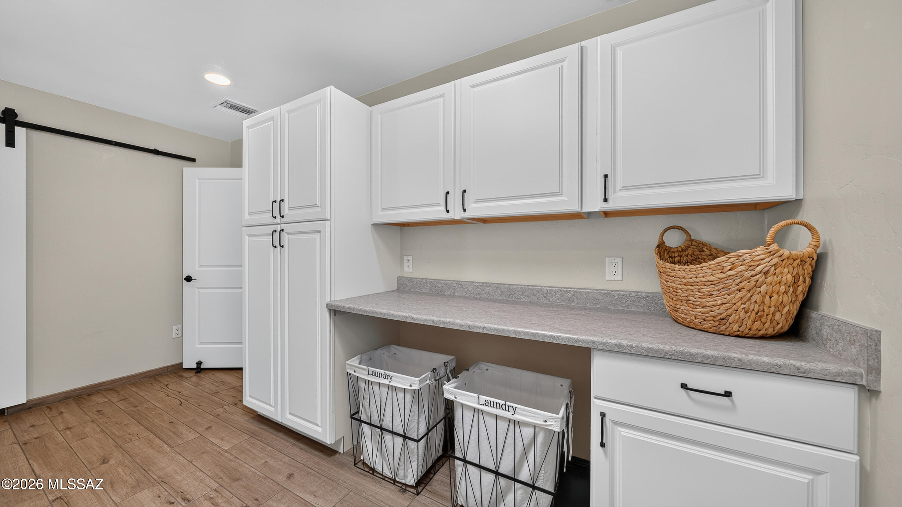 194 Taylor Road Willcox, AZ 85643 - Photo 33 of 54 Laundry Room - excellent functionality with extensive cabinetry, a dedicated folding counter, extra storage space, and room to keep laundry organized and out of sight.