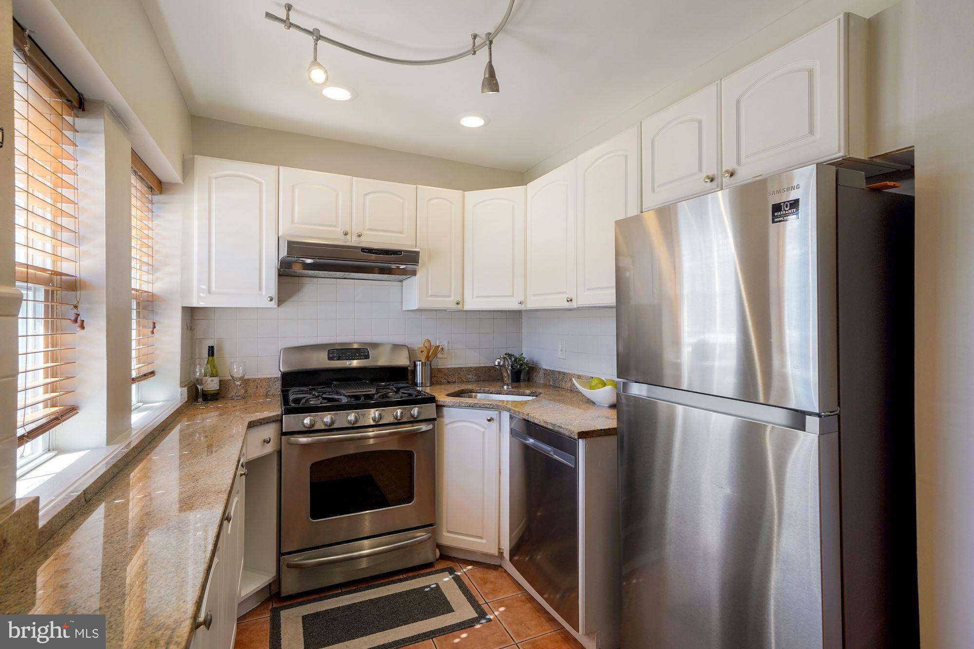 40 R Street Northwest Washington, DC 20001 - Photo 11 of 59 a kitchen with stainless steel appliances a refrigerator sink and cabinets