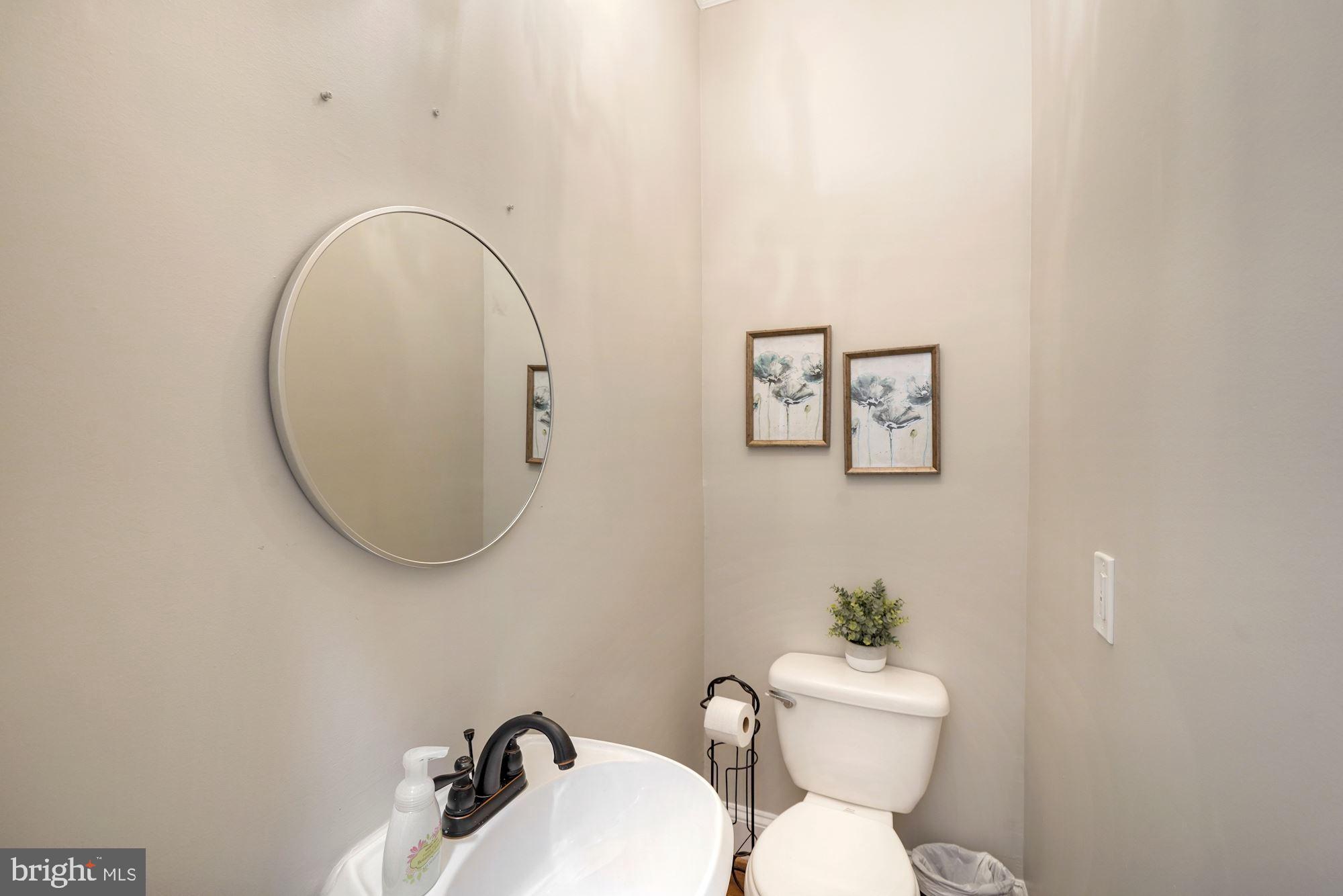 40 R Street Northwest Washington, DC 20001 - Photo 13 of 59 a bathroom with a toilet a sink and mirror
