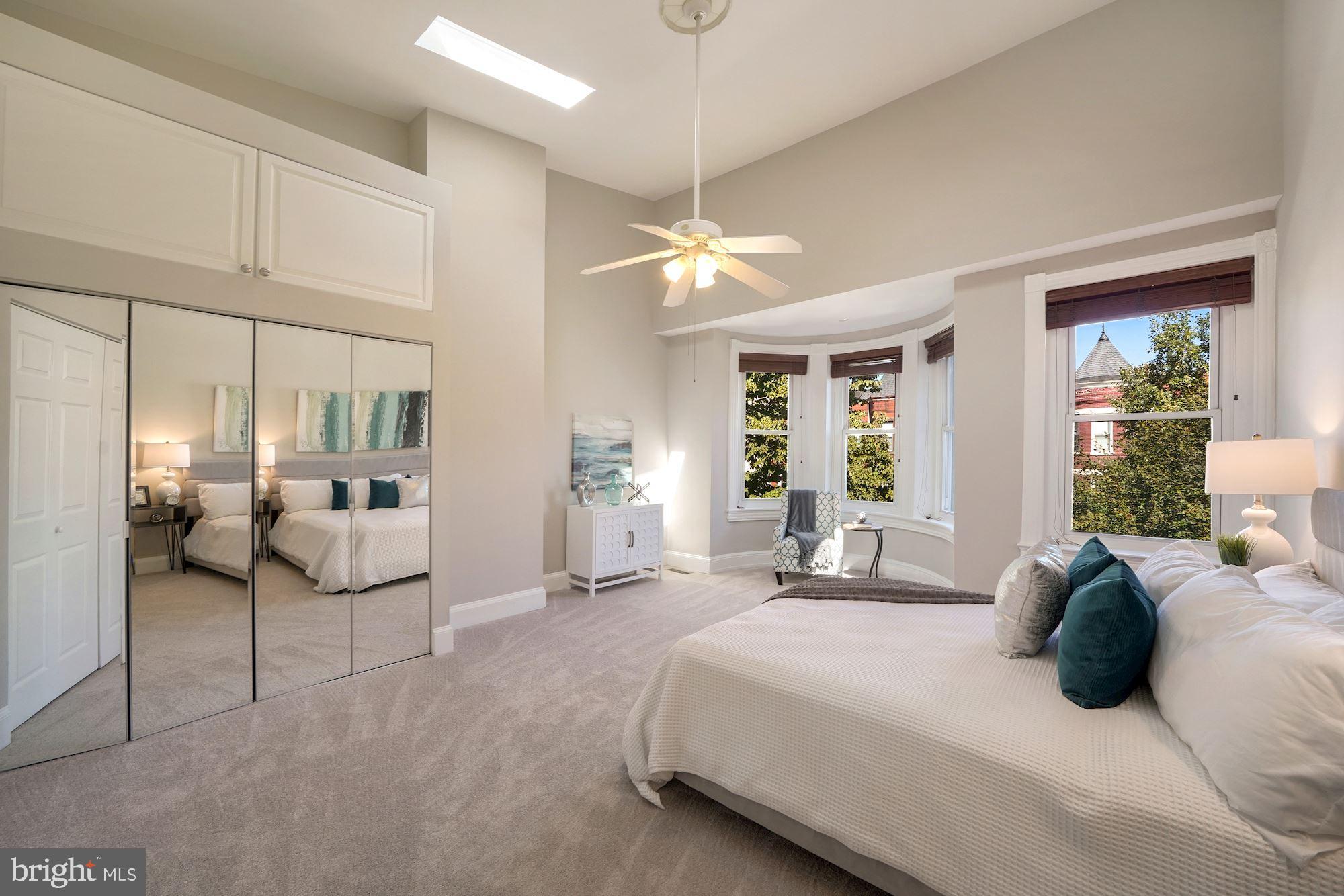 40 R Street Northwest Washington, DC 20001 - Photo 16 of 59 a bedroom with a bed a large mirror and furniture