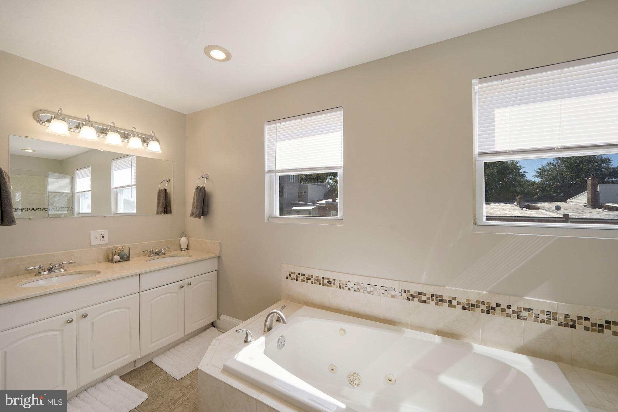 40 R Street Northwest Washington, DC 20001 - Photo 20 of 59 a bathroom with a bathtub sink and mirror