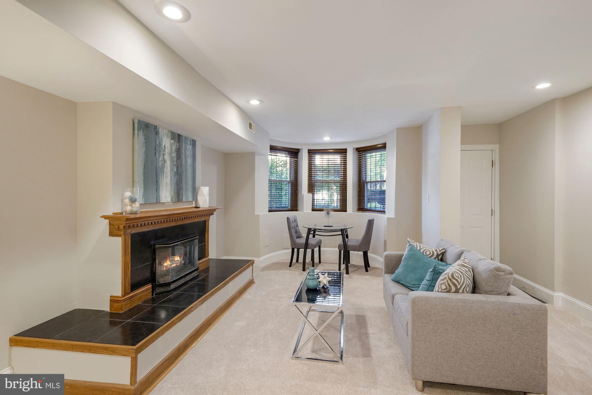 40 R Street Northwest Washington, DC 20001 - Photo 26 of 59 a living room with furniture a window and a fireplace