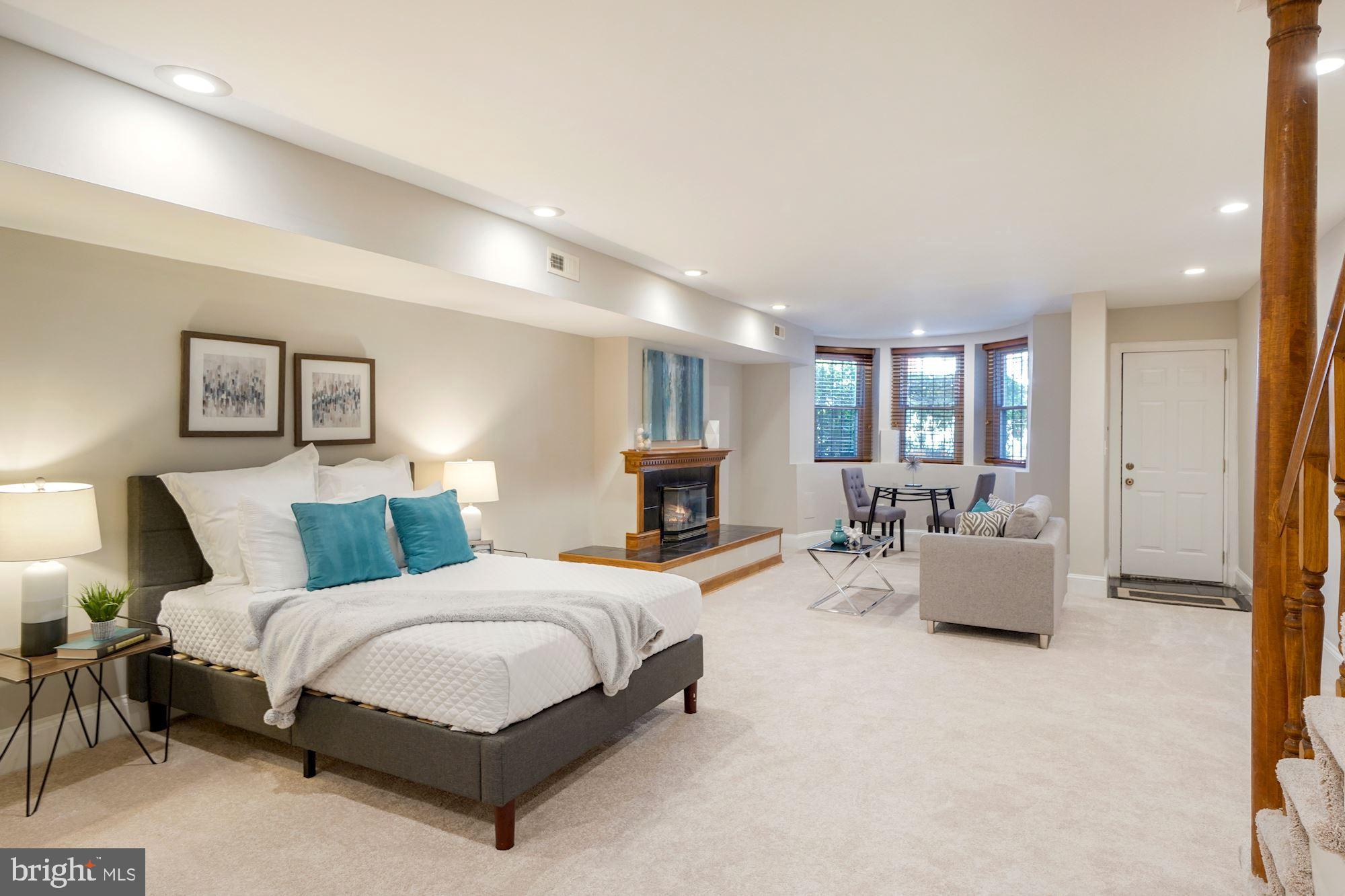 40 R Street Northwest Washington, DC 20001 - Photo 30 of 59 a spacious bedroom with a bed and couch