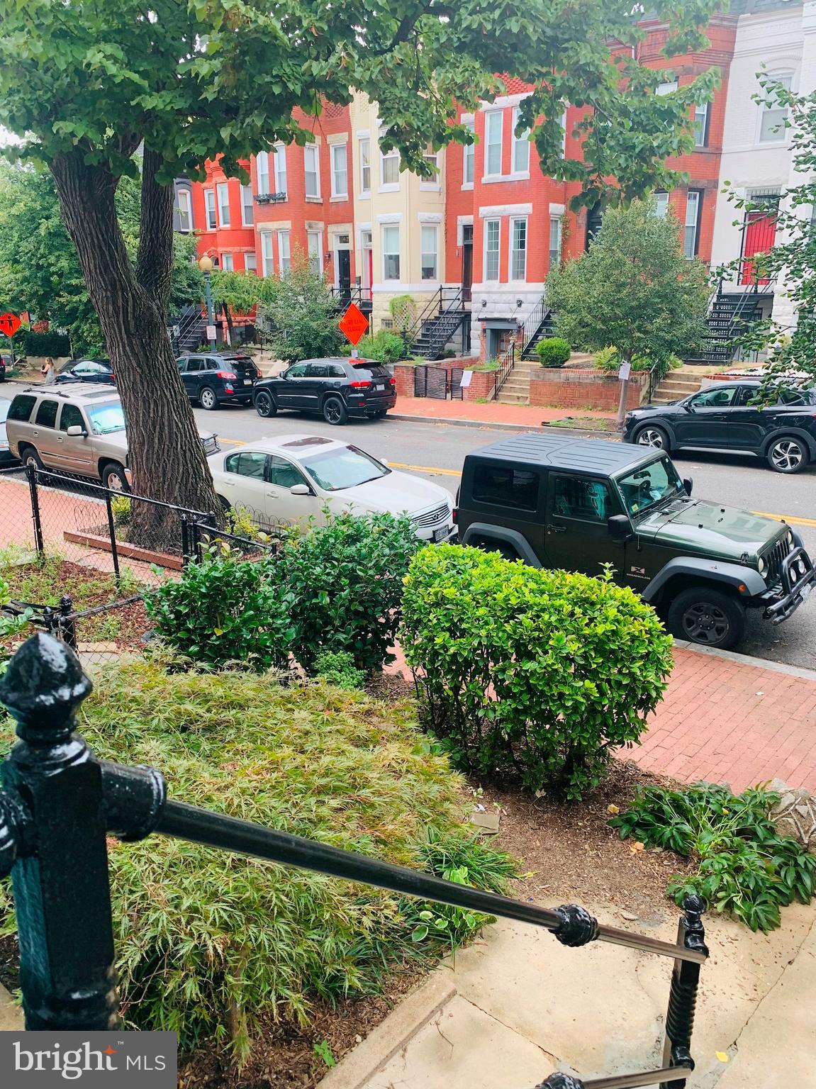 40 R Street Northwest Washington, DC 20001 - Photo 42 of 59 a street view with tall buildings and a yard