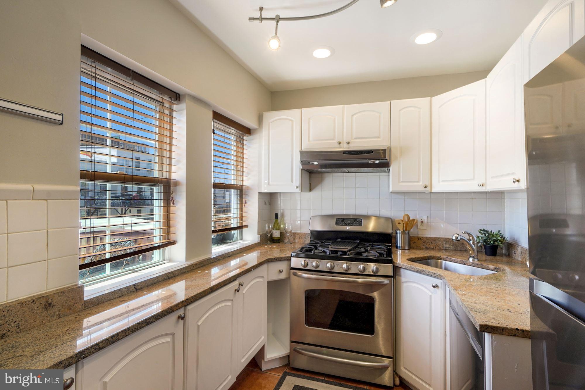 40 R Street Northwest Washington, DC 20001 - Photo 10 of 59 a kitchen with stainless steel appliances a stove sink and cabinets