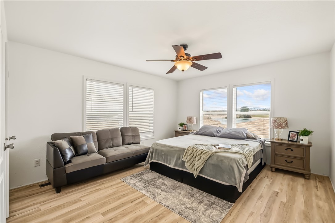 1286 Dike Road Mohave Valley, AZ 86440 - Photo 25 of 35 a bedroom with a bed a couch and a window