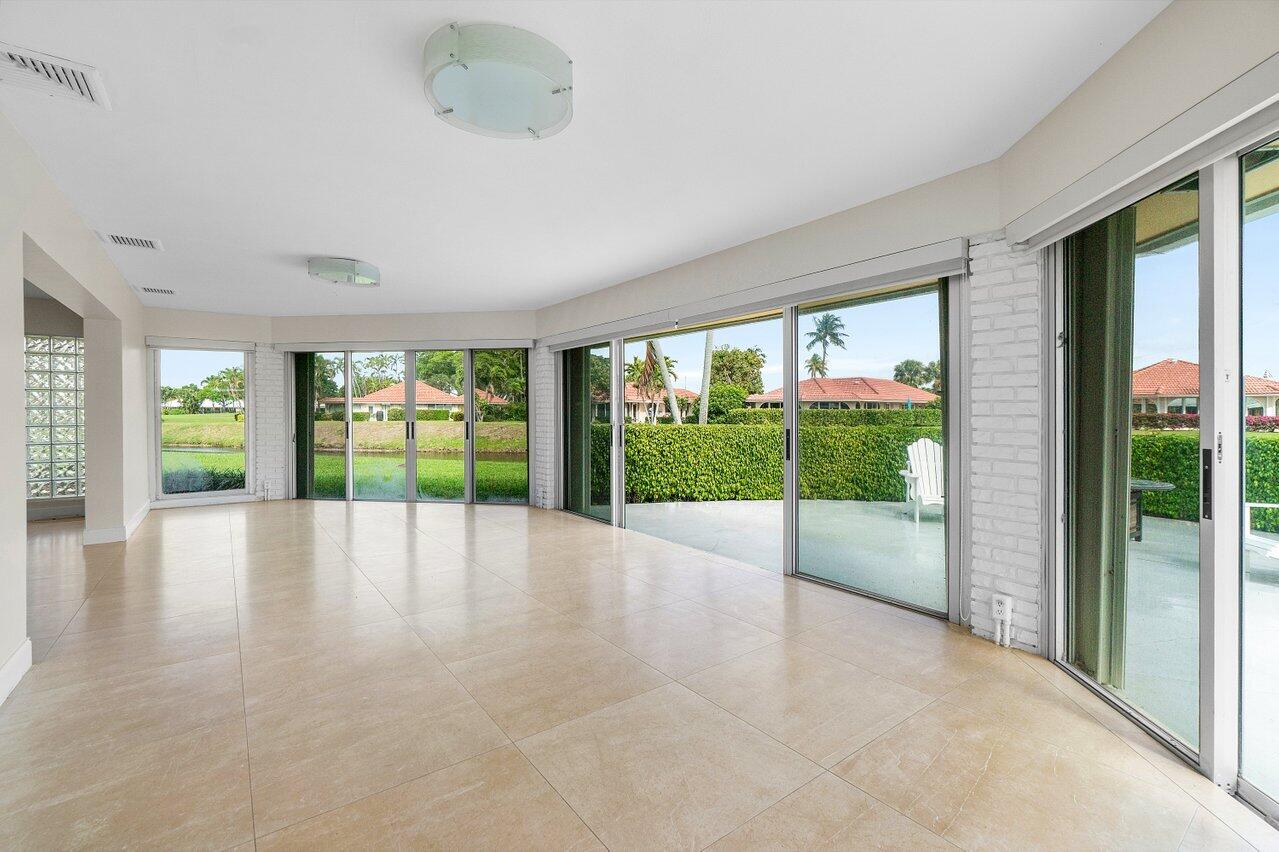 362 Yorktowne Circle Atlantis, FL 33462 - Photo 12 of 41 a view of an empty room with wooden floor and a window